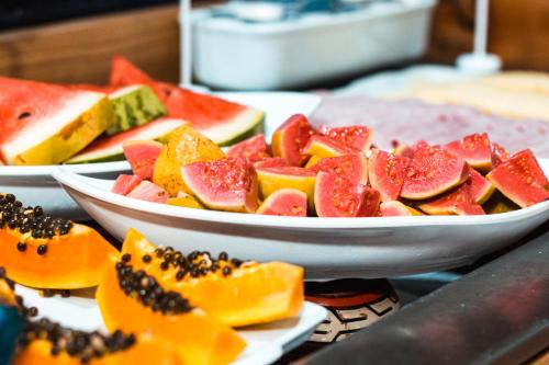 a bunch of plates of fruit on a table at ibis budget Belem in Belém