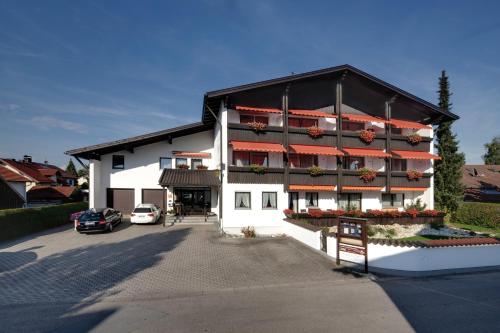 a large white building with red balconies on it at Appartementhaus Absmeier in Bad Füssing