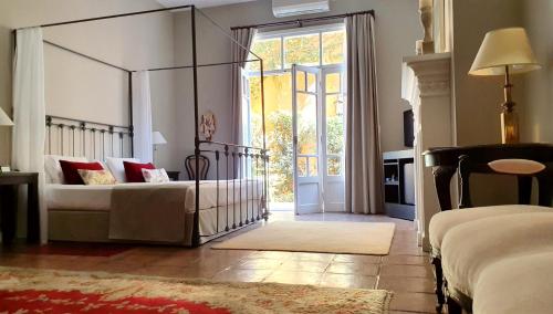 a room with a bed, a chair and a window at Legado Mitico Salta Hotel Boutique in Salta