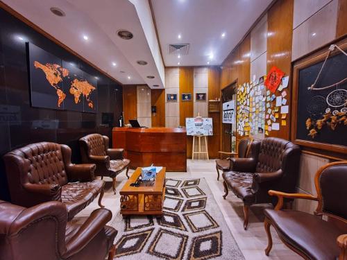 a waiting room with leather chairs and a table at Tahrir Square Hostel in Cairo