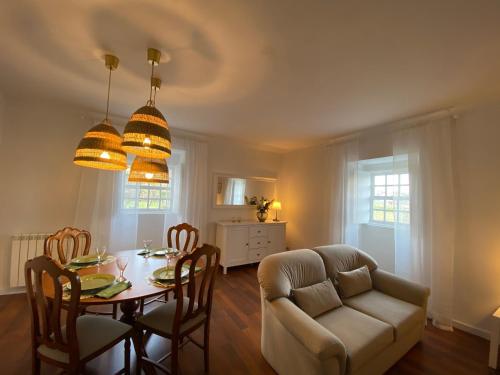 a living room with a table and a couch at Turra Nature House in Celorico de Basto