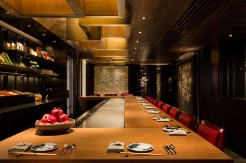 a long dining room with a long table and chairs at Grand Hyatt Hong Kong in Hong Kong
