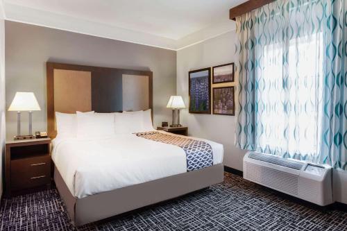 a hotel room with a bed and a window at La Quinta by Wyndham Seguin in Seguin