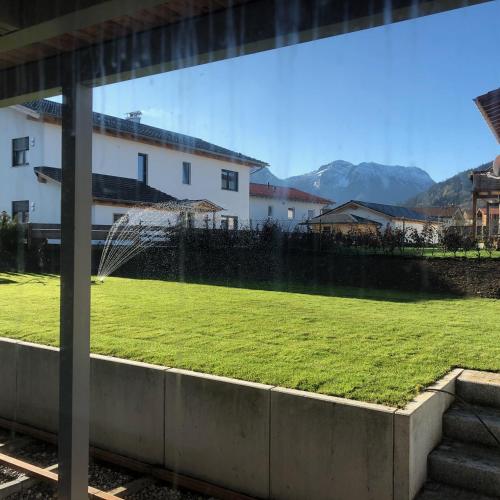 a view of a field of green grass in front of a building at Ferienhaus Chalets Inzell in Inzell