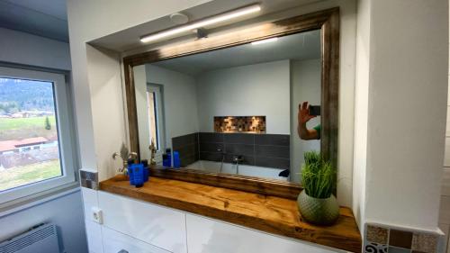 a large mirror in a bathroom with a sink at Ferienhaus Chalets Inzell in Inzell