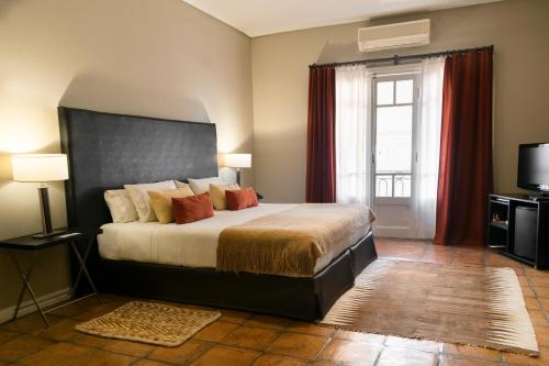 Postel nebo postele na pokoji v ubytování Legado Mitico Salta Hotel Boutique