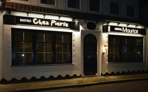 a building with a sign that reads sister cheese practice at Hotel Maurice in Nieuwvliet