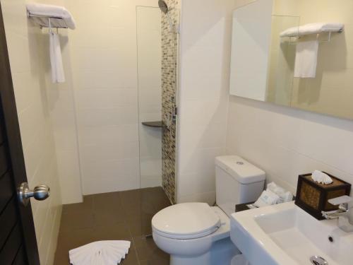 a bathroom with a toilet and a sink at Good Day Phuket Hotel in Phuket