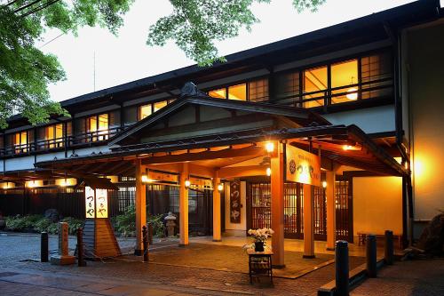 a building with a lot of windows and lights at Tsuruya Ryokan in Karuizawa
