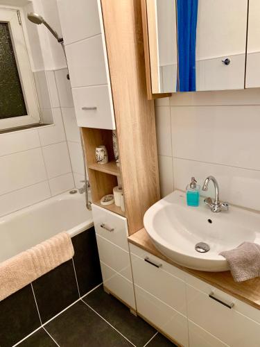 a bathroom with a sink and a bath tub at Big and Beautiful in Hannover