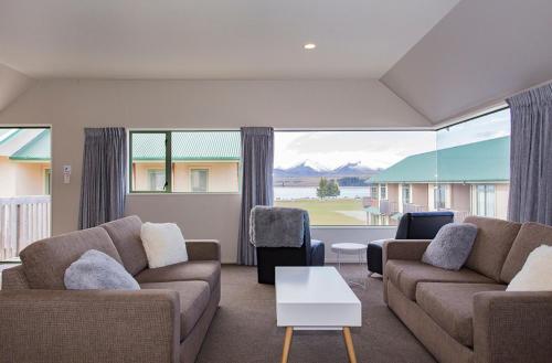 a living room filled with furniture and a window at Lake Tekapo Village Motel in Lake Tekapo