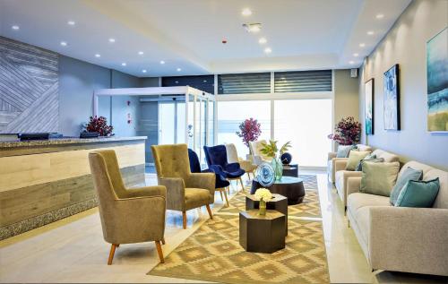 a living room with couches and chairs at Nobile Hotel Estación Central in Santiago