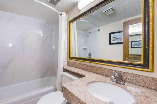 a bathroom with a sink and a mirror at Quality Inn in Gastonia