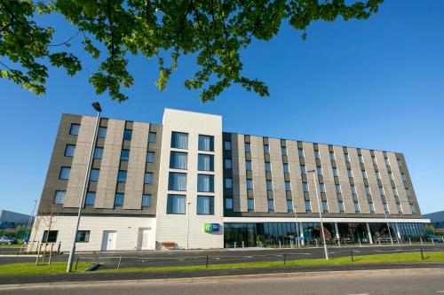 a large building with a clock on the front of it at Holiday Inn Express Bridgwater M5, Jct24, an IHG Hotel in Bridgwater
