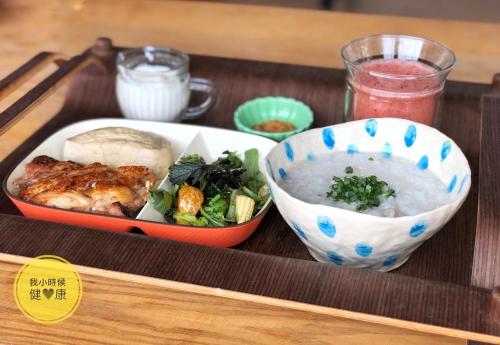 a tray with a bowl of food and a bowl of soup at Anping Wikid Design Hotel in Tainan