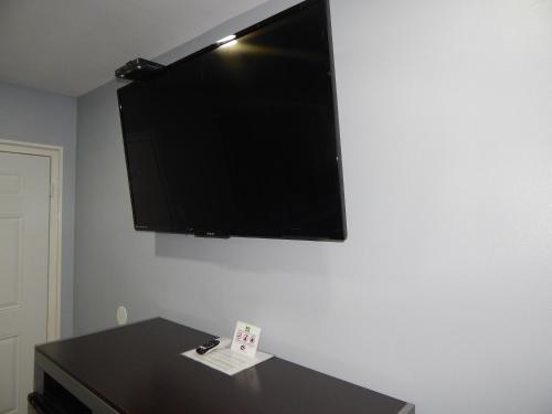 a flat screen tv hanging on a wall at Executive Inn Fort Stockton in Fort Stockton