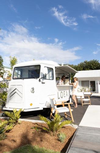 a white van parked with two people sitting in it at Loea Boutique Hotel in Maroochydore
