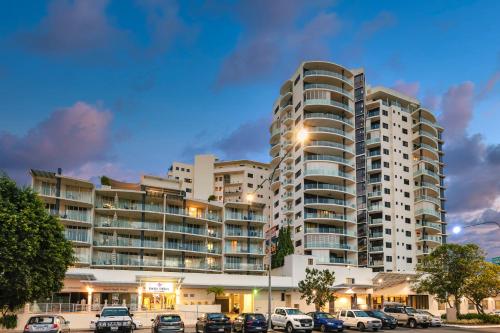 a large building with cars parked in front of it at Park Regis City Quays in Cairns