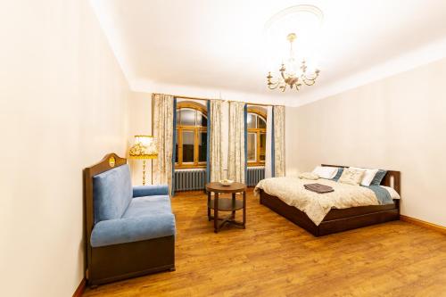 a bedroom with a bed and a blue chair at Cozy Storie's AP, 47sqm, Renovated 2020, Free parking in Riga