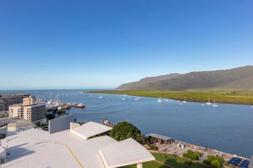 a large body of water with a lighthouse at Piermonde Apartments Cairns in Cairns