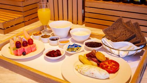 a tray with plates of food on a table at The Mangrovetree Sanya Resort in Sanya