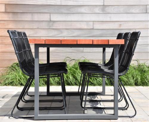 a table with four black chairs around it at Vakantiewoning Lescaut in Hamme