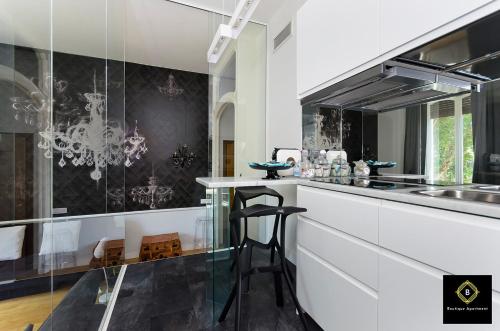 a kitchen with a counter with a bar in it at Boutique Apartment Glamour Torino in Turin