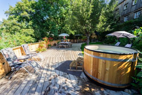 a wooden deck with a hot tub and a patio at Landhaus Alpentraum in Kaning