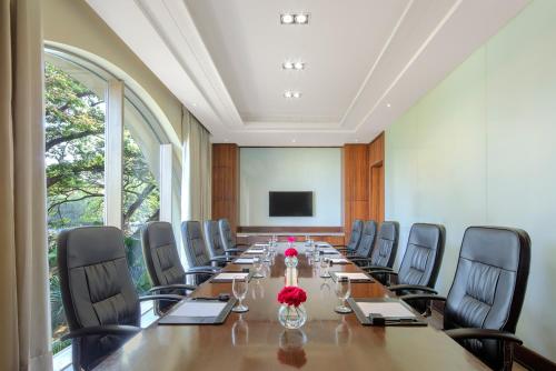 a large conference room with a long table and chairs at Radisson Blu Plaza Hotel Mysore in Mysore