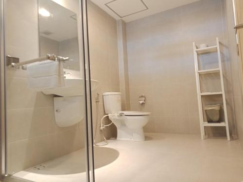 a bathroom with a toilet and a sink and a shower at The White Garden Premier Saraburi in Ban Dao Ruang