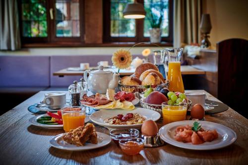 a breakfast table with breakfast foods and orange juice at Ringhotel Gasthof Hasen in Herrenberg