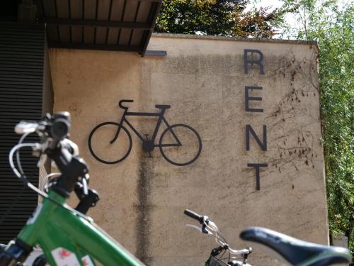 a sign with a bike on the side of a building at Apartments Sabine G in Merano