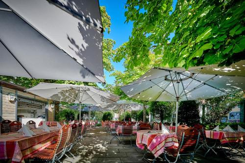 a row of tables and chairs with umbrellas at Ringhotel Gasthof Hasen in Herrenberg