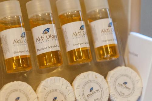 a group of four bottles of oil in a box at Elounda Akti Olous (Adults Only) in Elounda