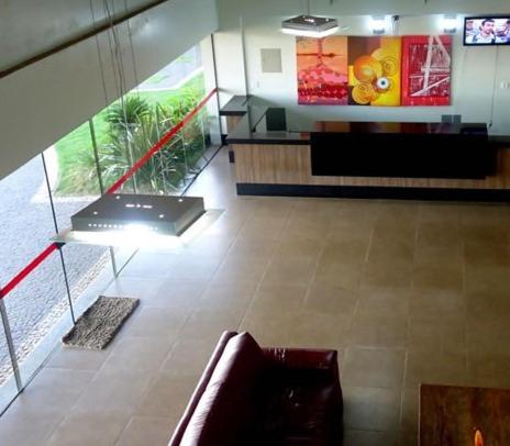 a living room with a couch in the middle of a building at Senador Plaza Hotel in Senador Canedo