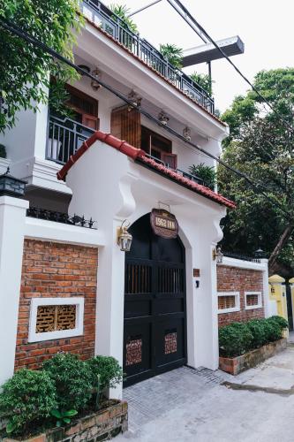a house with a black door and a brick building at Hue 1962 INN in Hue