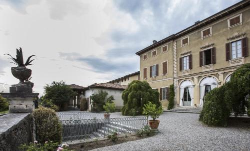 a large building with a fence in front of it at Villa Redona in Entratico