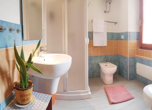 a bathroom with a sink and a toilet at Acqua Chiara Alghero in Alghero