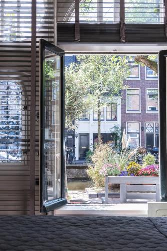 an open sliding glass door with a bench outside at Villa360 in Amsterdam