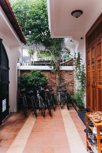 a group of bikes parked against a brick wall at Hue 1962 INN in Hue