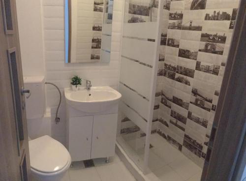 a white bathroom with a sink and a toilet at EUROPEAN HOUSE in Constanţa