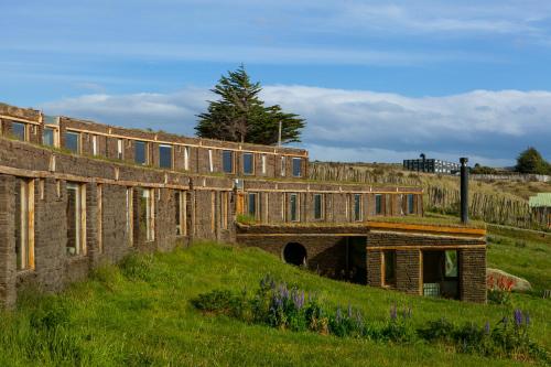 an old brick building on a hill with a tunnel at Hotel Altiplanico Puerto Natales in Puerto Natales