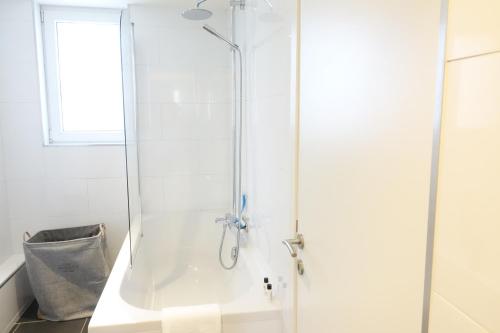 a shower with a glass door in a bathroom at The Roof - Rooftop appt in historical center in Antwerp