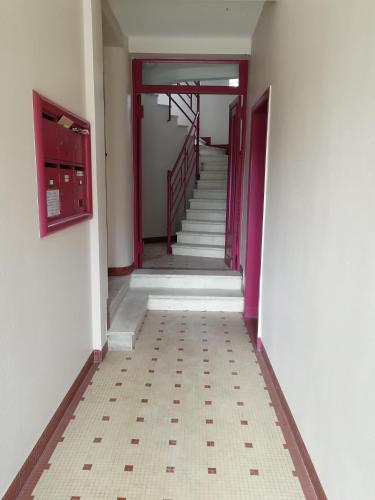 an empty hallway with stairs in a building at L'Escale Fougeraise in Fougères