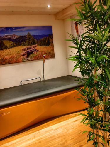 a bench in a room with a painting on the wall at Haus Mariandl in Nesselwängle