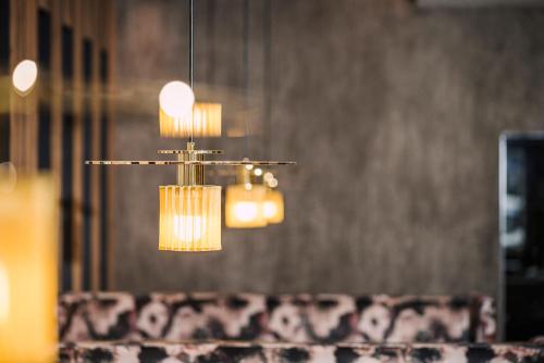 a chandelier hanging over a table in a room at Alpin Family Resort Seetal in Kaltenbach