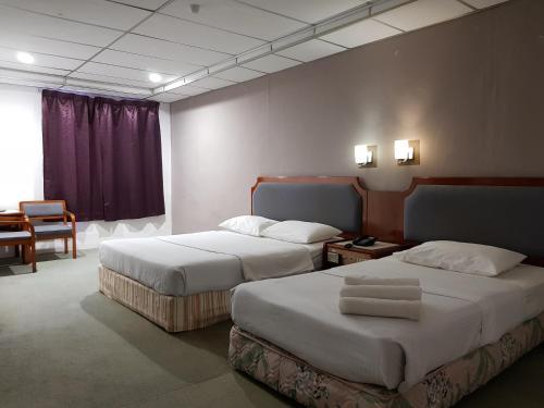 Postel nebo postele na pokoji v ubytování Anika Inn - Kluang