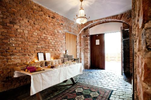 a room with a brick wall and a table with food at Rex Hotel in Stockholm