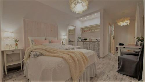 a bedroom with a large bed with a blanket on it at Pokoje Gościnne Puławska 41 in Kazimierz Dolny