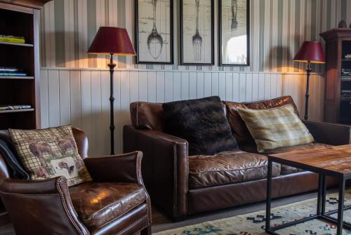 a living room with a couch and two chairs at Sälens Högfjällshotell in  Högfjället